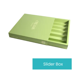 A green cardboard box labeled "Chocolate Box" with the text "CERAMYS" on the lid. The partially open lid reveals multiple compartments inside, reminiscent of a classic chocolate box. At the bottom of the image, a blue label reads "Slider Box.